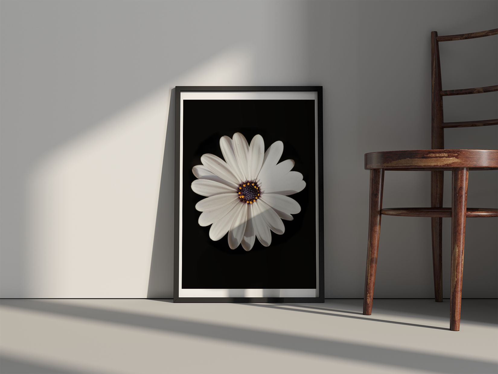 Serenity print in a black frame with white border. Laying against a white wall on a white floor next to a dark brown wood chair.