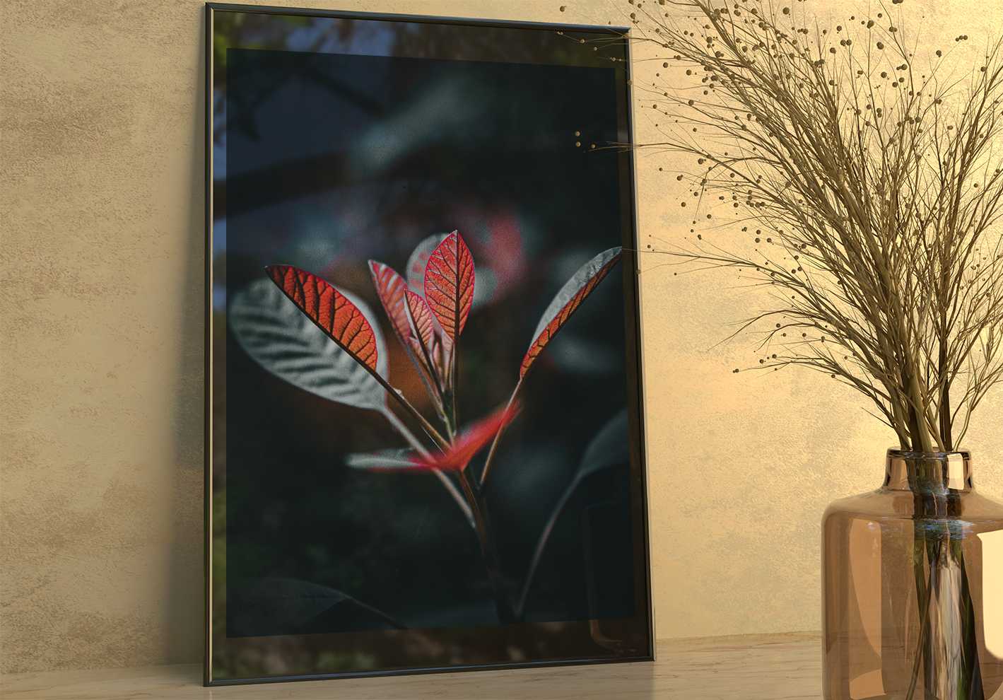 Spotlight inbetween glass on a thin black frame. Leaning against a cream yellow wall infront a dried plant in a glass vase. 