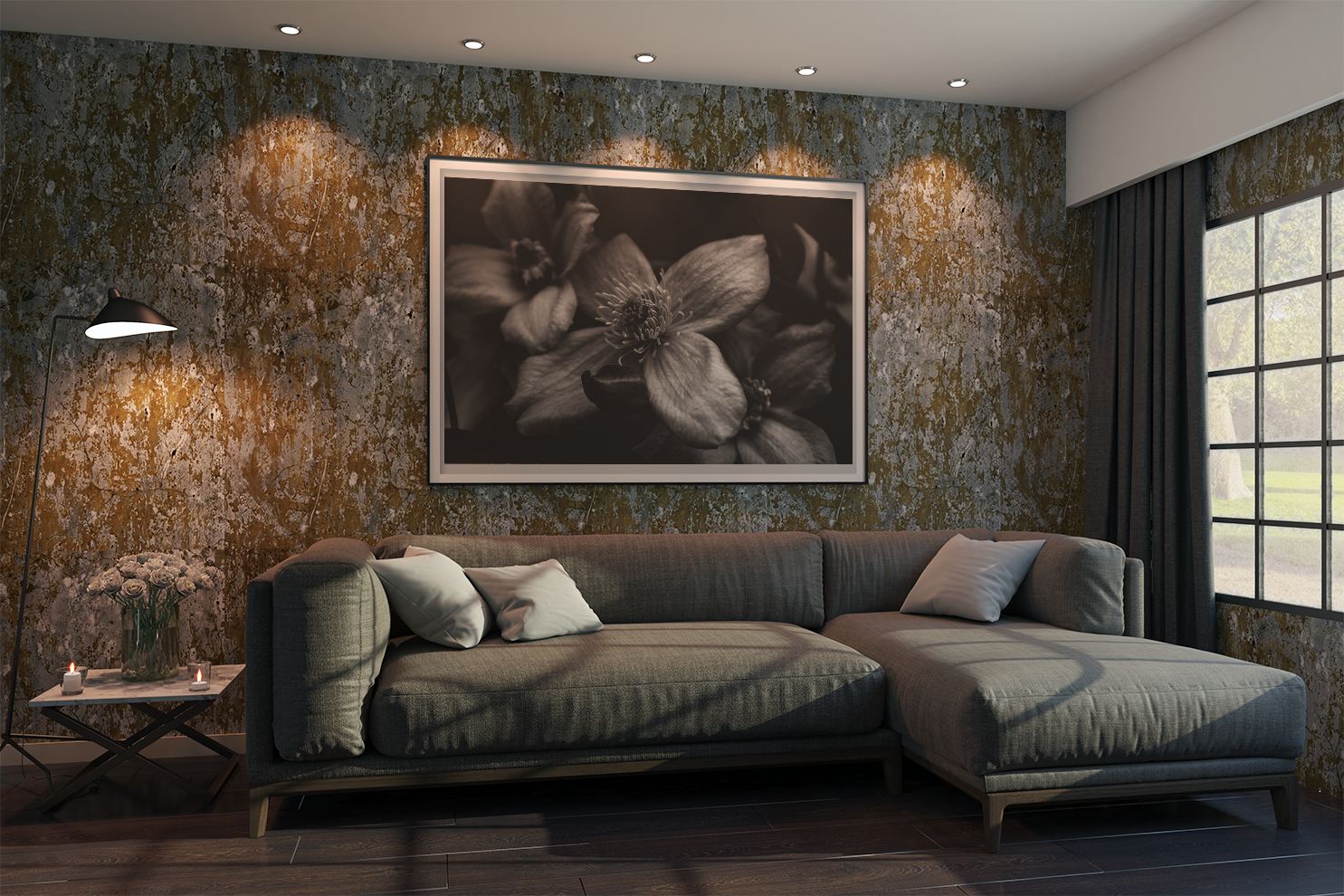 Macro flowers in a black frame in white card. Against a textured grey and umber textured wall. Setting is a living room, L-shaped sofa with a lamp beside it. Natural light coming in from window to the right. 