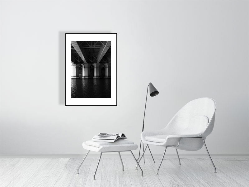 Industrial past print showcased in a black frame in minimalist room 