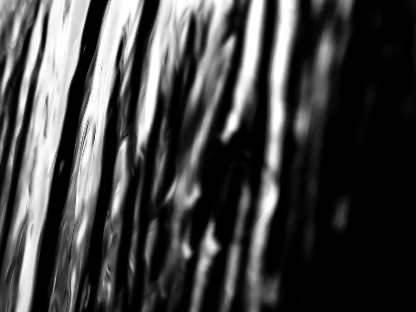 Black and White, ripples over entire image. An abstract closeup, veil or curtain like texture.