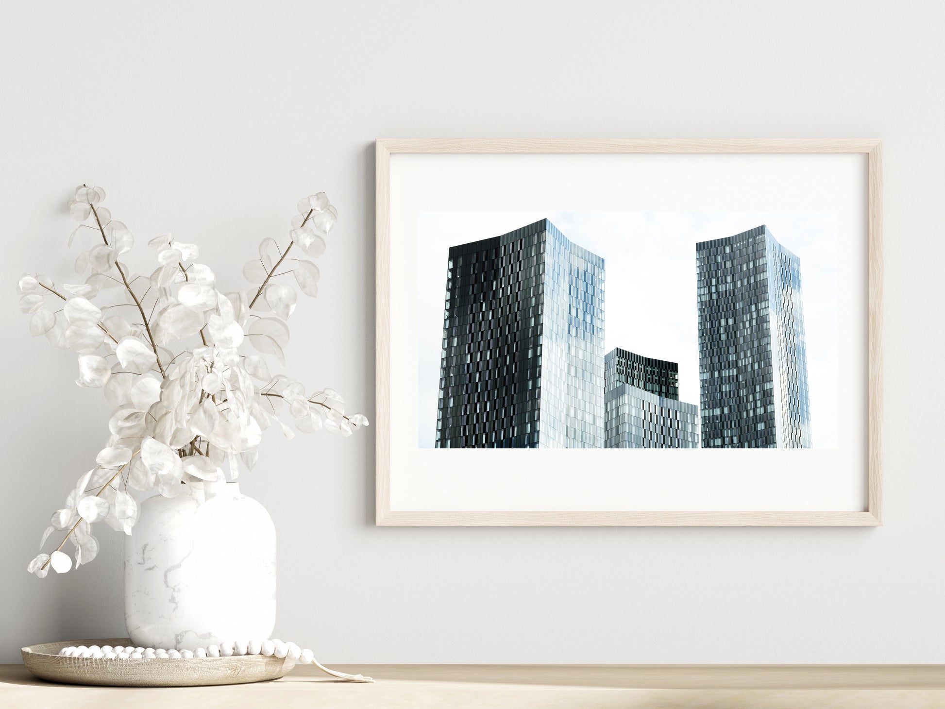 Skyline blues print showcased in a template for a room setting with minimalist plants, as it would be if purchased displayed